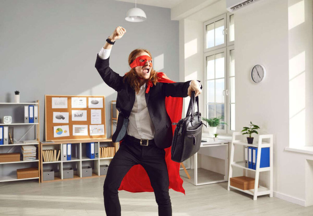man in office dressed up as super hero fooling around.