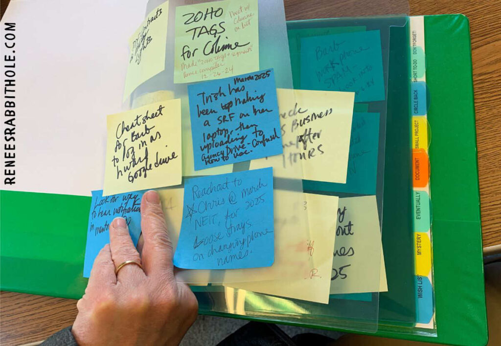 Binder showing post-it-note solution for tech support ticket system.